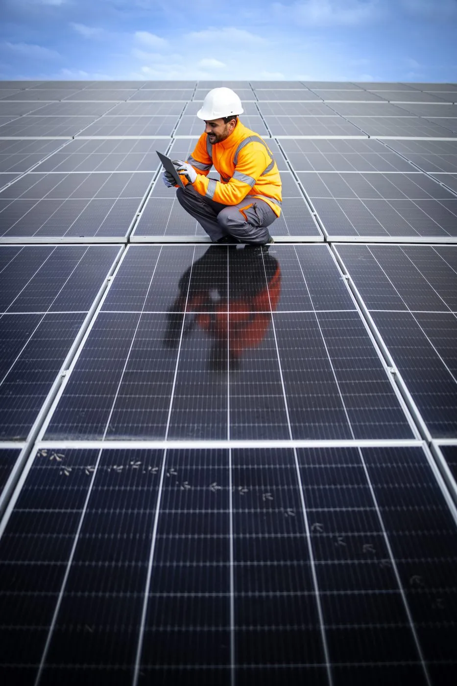 Utilities worker inspecting solar panels